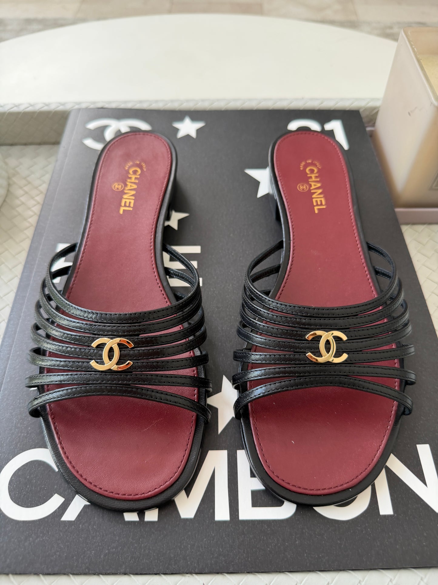 Chanel 2026 Métiers d'Art Blazy Black Leather Strappy Gold CC Logo Flat Sandals Slides