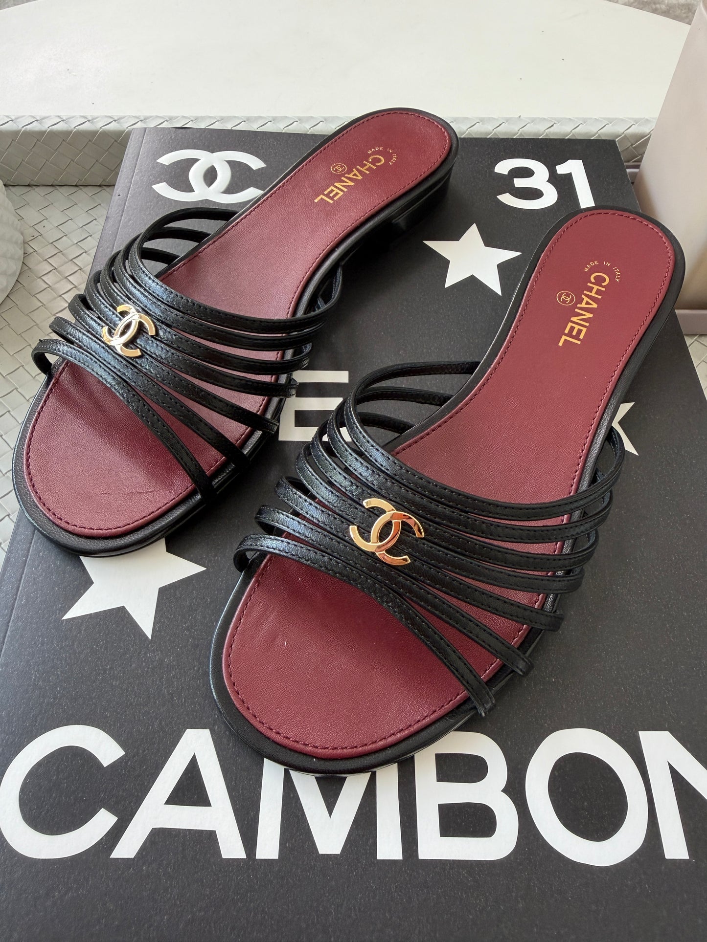Chanel 2026 Métiers d'Art Blazy Black Leather Strappy Gold CC Logo Flat Sandals Slides