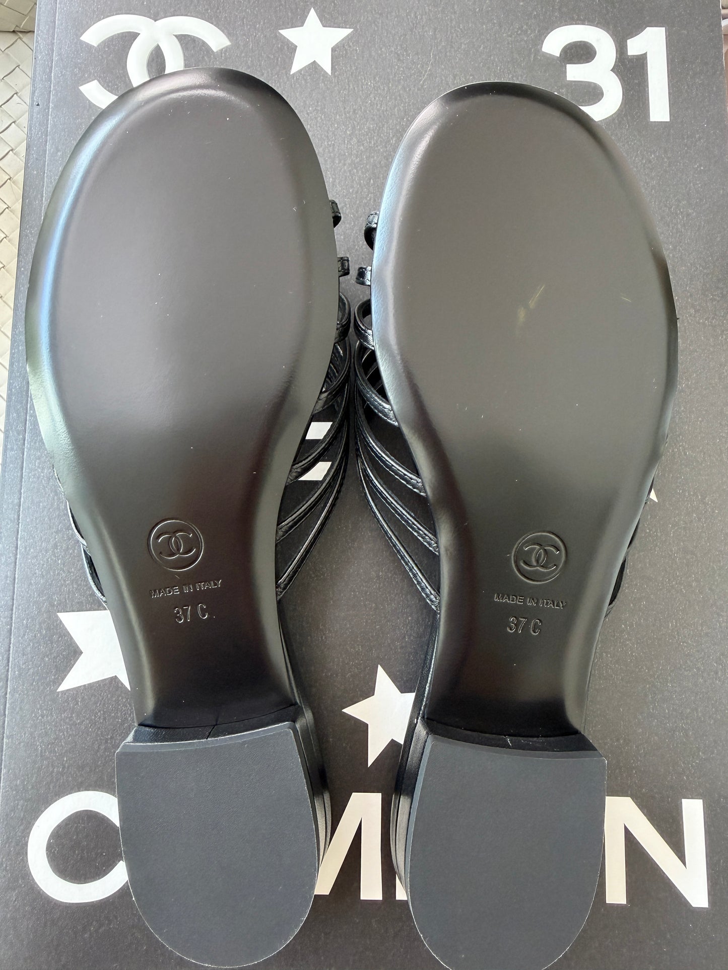 Chanel 2026 Métiers d'Art Blazy Black Leather Strappy Gold CC Logo Flat Sandals Slides