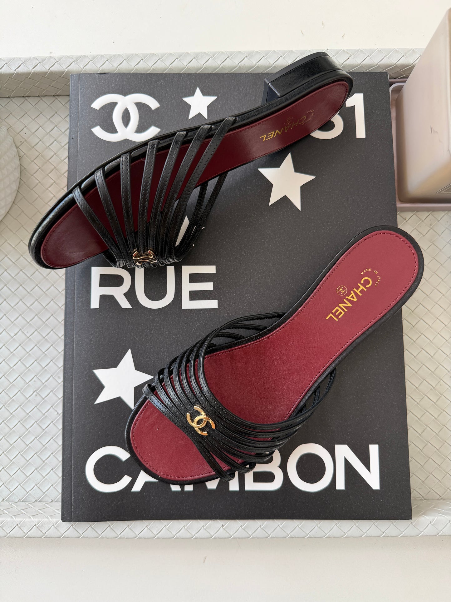 Chanel 2026 Métiers d'Art Blazy Black Leather Strappy Gold CC Logo Flat Sandals Slides
