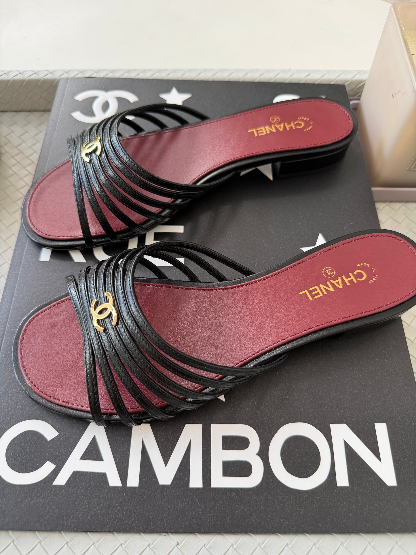 Chanel 2026 Métiers d'Art Blazy Black Leather Strappy Gold CC Logo Flat Sandals Slides