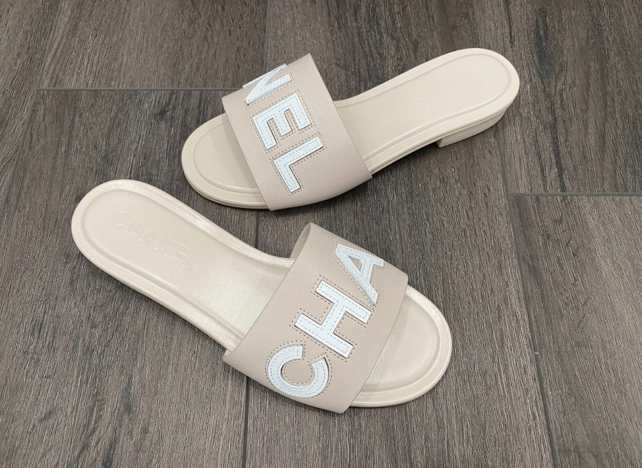 CHANEL CHA NEL LOGO BEIGE LEATHER FLAT SHOES SLIDES MULES – Miami Lux  Boutique