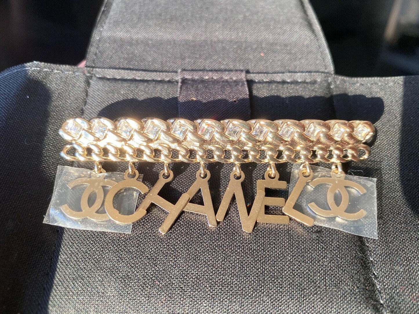 CHANEL GOLD "CHA"NEL" CC LOGO WHITE CRYSTALS CHARMS BROOCH PIN